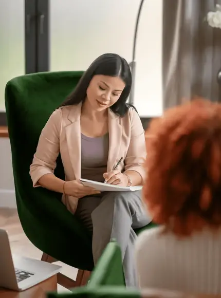 Therapist taking notes during client consultation session